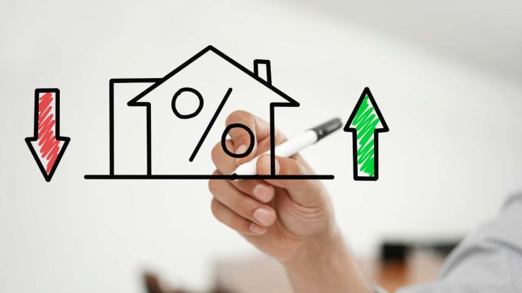 Ar mārkeri uzzīmēta māja iekš kuras % un sānos bultiņas uz leju un augšu – kas ietekmē pirmo iemaksu hipotekārajam kredītam